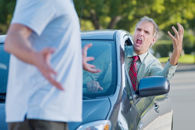 A driver yells at the pedestrian he almost hit.
